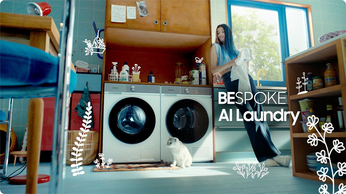 A woman sits on the floor and plays with her cat in front of a white Bespoke AI™ washer and dryer set. The laundry is spinning inside the washer on the left. Stylish. A man is sitting on a countertop reading a magazine and drinking a cup of coffee. Below the counter is a black Bespoke AI™ washer and dryer set. Energy saving. Then it switches to a close up of fabric covered in detergent bubbles. AI Ecobubble™. Inside of a washer is shown. A wave of water rushes forward. Wash cool. A white Bespoke AI™ washer and dryer set is stacked on top of one another in a blue kitchen. 11kg Large capacity. A woman is sitting in a bright entryway. She is spraying a plant with water near a white Bespoke AI™ washer and dryer with Morning Blue panels stacked on top of each other, built into a blue cabinet. Less Energy. A man is walking through a doorway into a room while pushing a bike. In the back of the room is a black Bespoke washer and dryer set placed under a counter. More Capacity. The first woman with her cat appear. She is leaning on the cabinet and a cat is sitting in front of the dryer. BESPOKE AI Laundry.