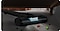 There is a Samsung Jet stick vacuum with a slim LED Brush+ reaches underneath a sofa to vacuum dirt. LED lighting is on.