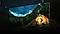 A TV vividly displays a camper amidst stunning mountain scenery at night, with the breathtaking view seeming to expand beyond the confines of the screen.