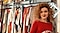 A woman standing next to a clothing rack