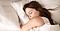 Close up of woman asleep in bed