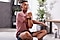 Man in gym clothing with Galaxy Buds2 stretching and warming up before exercise