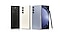 Three Galaxy Z Fold5 devices. Two are folded and seen from the rear, shown in Phantom Black and Cream. The third is in Icy Blue and is unfolded and seen from the rear. S Pen Fold Edition for Galaxy Z Fold5 leans on the side.