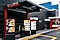 Three digital menuboards are displaying burger promotions on Samsung smart outdoor signage, OHF series, on the way to order McDonald's.