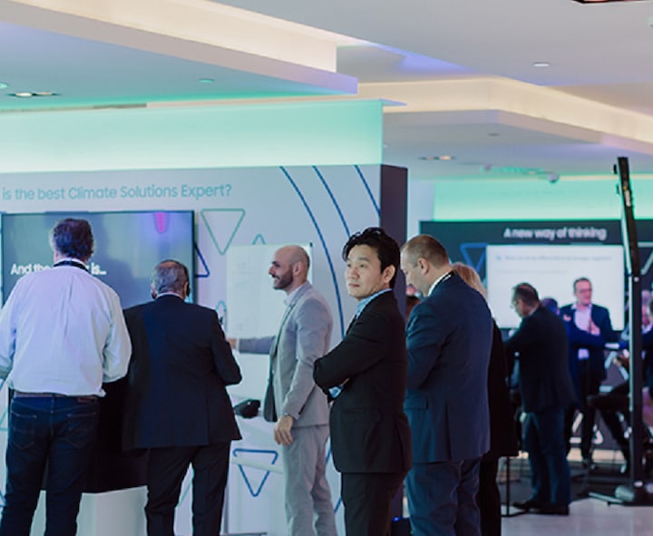 Attendees at booths at the Samsung climate solutions days