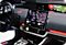A computer-generated image of the inside of a black, futuristic car dashboard with cellular V2X (Vehicle-to-Everything) tech