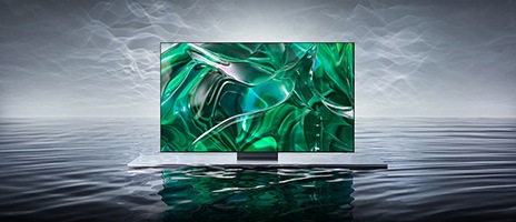 Η τελευταία τηλεόραση Samsung OLED παρουσιάζει ένα ευκρινές πράσινο γραφικό στην οθόνη της καθώς επιπλέει πάνω σε μια γκρι επιφάνεια.