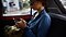 Woman in a car safe surfing on her phone