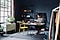 A wide shot of a man sitting at a desk, he is in a large room that seems to be his home office