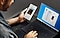 An over-the-shoulder shot of a man holding a Galaxy Note10 in his left hand and using the trackpad of a Galaxy Book S in his right, there are messages on both screens