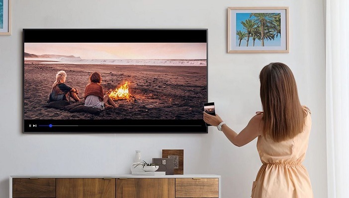 a woman tapping phone on the tv