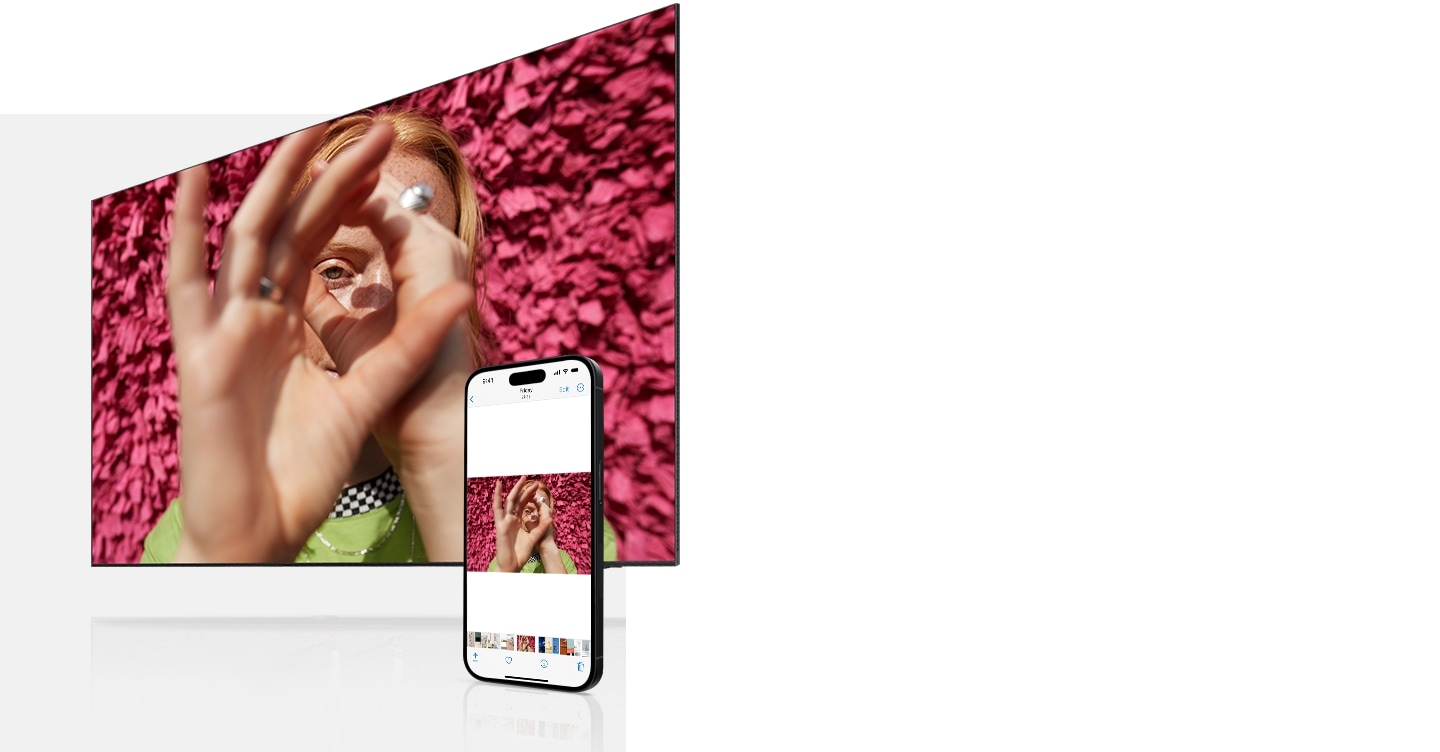 Whatever image is shown on the iPhone's screen simultaneously appears on the Samsung TV. The images change from a woman shown cupping her eyes, a person playing with blocks and a bright yellow chair.