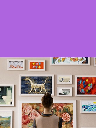 A woman is looking at various art frames.