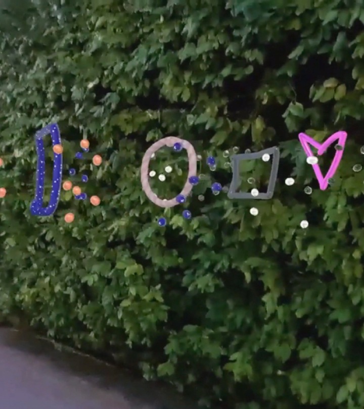 Dots, a star, circle, square and heart AR doodles against a backdrop of greenery