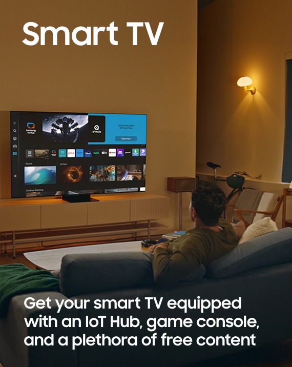 A man is viewing the Smart Hub home screen displayed on his Smart TV. The text Get your smart TV equipped with an IoT Hub, game console, and a plethora of free content is featured at the bottom.