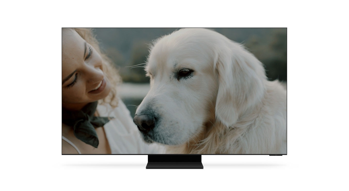 8K TV shows an 8K AI upscaled image of a woman hugging a dog completed by AI Neural Quantum Processor 8K.
