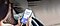 A person sitting on a sofa is looking at her Galaxy smartphone device. She is receiving a phone call from Christina Adams.