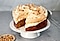 Coffee sponge cake topped with hazelnut meringue and fresh whipped cream.