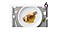 Step 6. The cooked trout is carefully plated, and then the vegetables and sauces are delicately arranged around and on the fish. A fork rests on the placemat, while flower petals and a leaf are added to accentuate the sophistication and beauty of the dish.