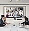 attending a video conference in the conference room.