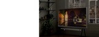 A Cloud White model of the Serif is seen in a stylish room with a bright window at its back. The onscreen image shows a scene of old buildings along a picturesque canal at night. As the brightness in the room changes to dark due to the natural light coming in through the window, The Serif automatically adjusts the brightness accordingly.