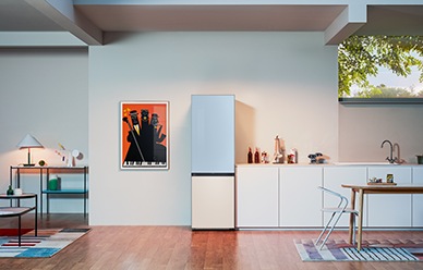 A Glam Lavender 1-door Bespoke refrigerator is in a modern kitchen next to a 2-door unit with a Clean White bottom and a Satin Sky Blue top panel, which is slightly opened.