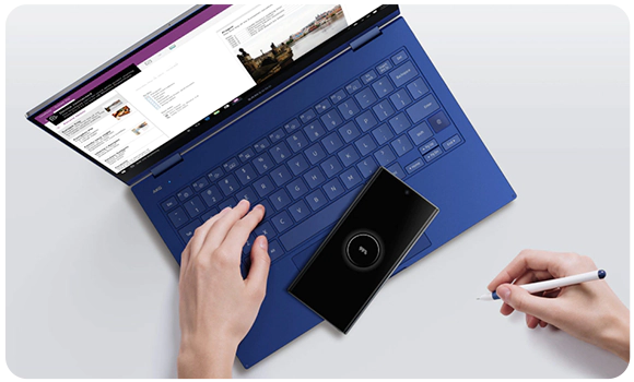 Galaxy Book Ion touchpad is charging a smartphone via Wireless PowerShare