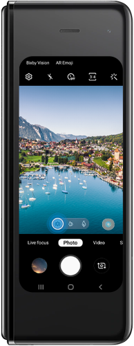 Tap the icon with the three trees to swap to the ultra wide camera