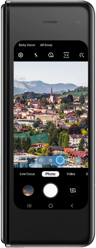 Tap the icon with one tree to swap to the telephoto camera