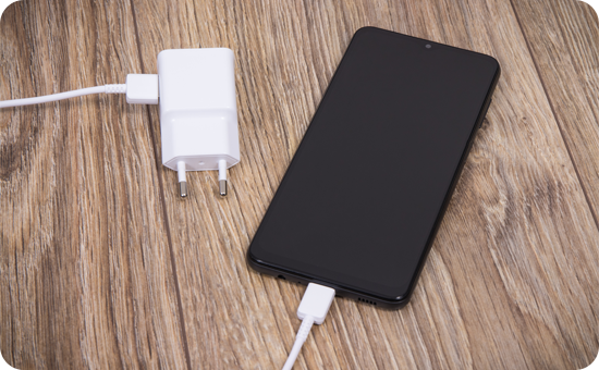 A Galaxy smartphone and its charger.