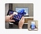 A person is using Galaxy Tab. Notification of an incoming call can be seen on the screen of the Galaxy Tab and a Galaxy Book in the same room. On the bottom right is a Galaxy smartphone placed on a stand displaying an incoming call.