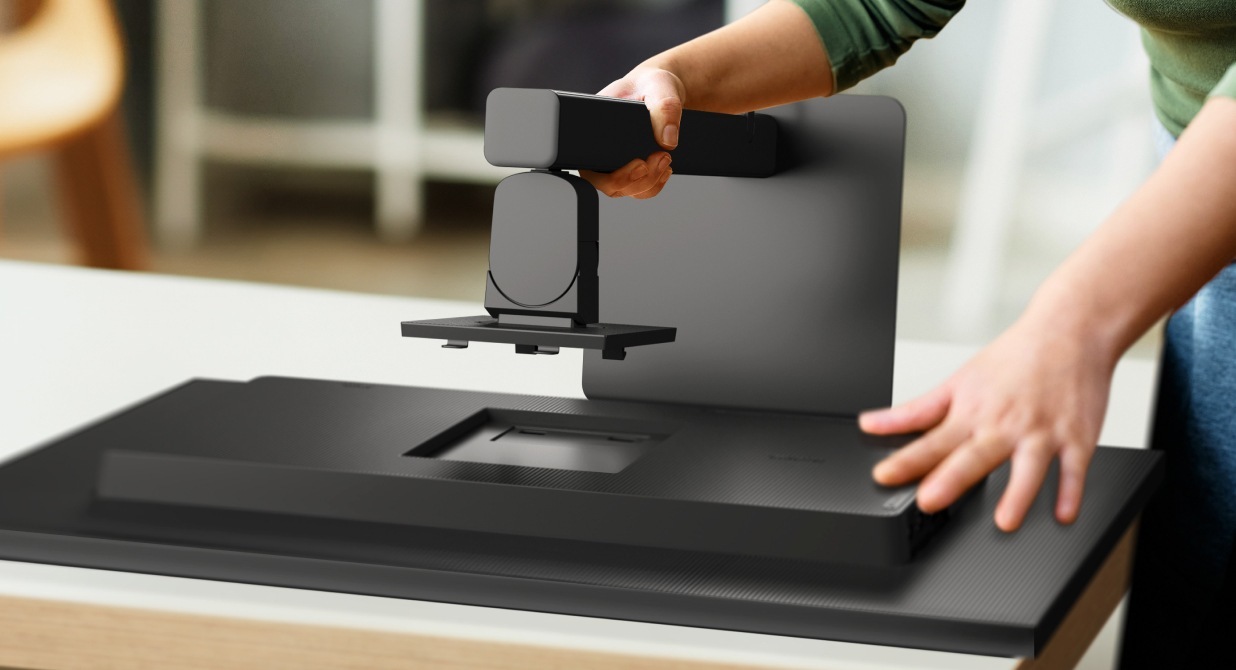 A Samsung ViewFinity monitor being assembled using the Easy Setup Stand. It is a tool-free installation process, with a user effortlessly attaching the rear of the monitor to the stand. The setup provides flexible viewing options for convenience and versatility.