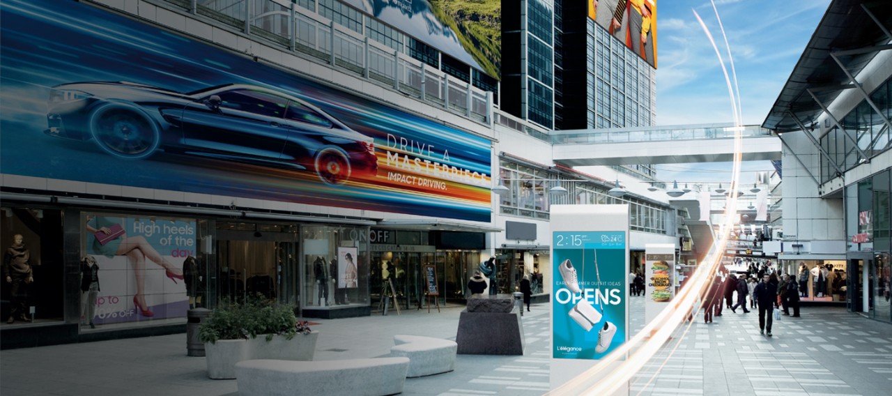 Various digital signages are installed on the window of the shop and building exterior walls, and on the road