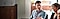 A man is pictured sat down, looking at the woman to his left who is out of focus whilst holding the silver laptop on his lap.
