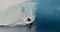 A male surfer is riding a massive wave.