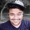 A man wearing a cap smiling