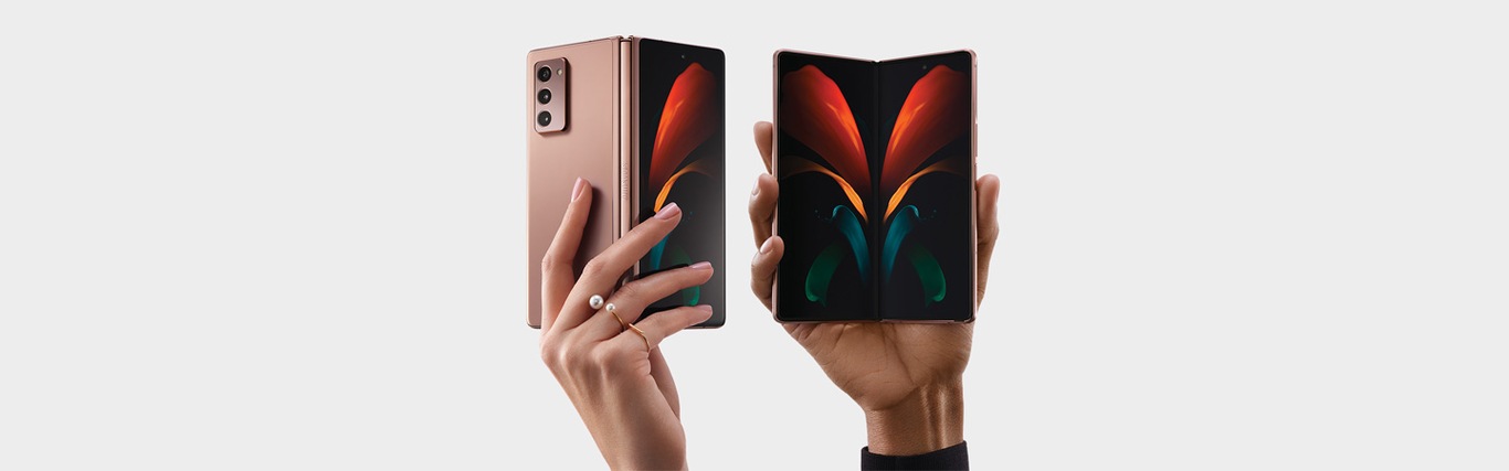 Samsung Galaxy Z Fold2 5G with 256gb storage, 12gb ram, mystic bronze is laid in Flex Mode and one is facing up on top