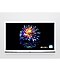 A Cloud White model of The Serif shows a colourful flower on a black screen with quantum dot technology.