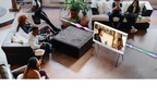 People are gathered and watching The Serif sitted in the middle of the room.To illustrate Active Voice Amplifier, image becomes dimmed as the noise around TV increases due the people. And Active Voice Amplifier automatically increases "voice clarity".