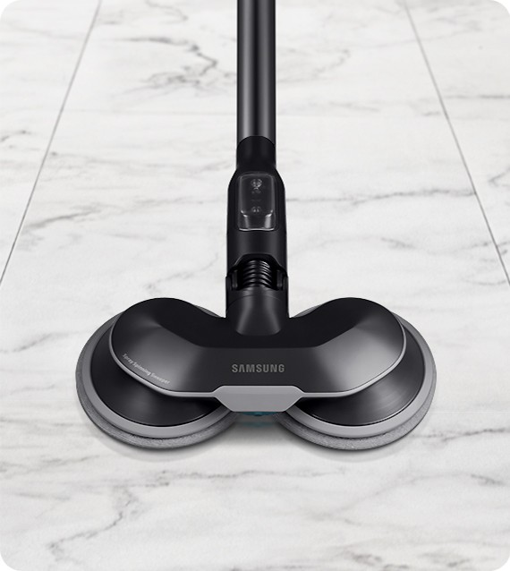 There is a close-up of a Spray Spinning Sweeper on a white marble floor.