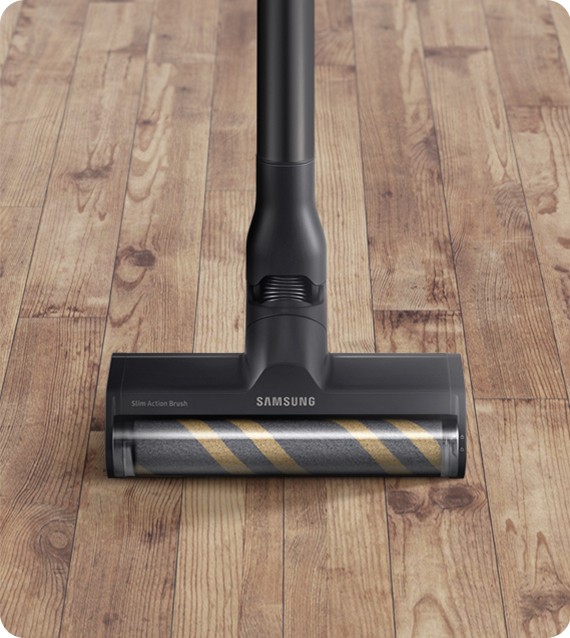 There is a close up of a Bespoke JET with a Slim Action Brush attachment cleaning a hardwood floor.