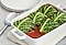There are cabbage rolls filled with lamb mix on an white oven tray.
