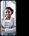 A product shot of a Galaxy S21 phone. A woman on screen poses, smiling confidently at the camera with her arms folded in front of her chest. She is wearing a grey blazer over a white striped shirt.