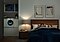 It’s night time. The couple is sleeping in their bedroom while the QuickDrive™ is washing close in the next room. The lights on the QuickDrive™ are on and the machine is running smoothly and quietly so they can sleep peacefully.