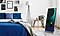 Inside a bedroom, The Sero TV is seen standing in a vertical position next to the bed without the need for a wall mount or additional stand. An artistically designed color and shape image can be seen on the screen.