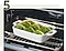 Step 5. There is an white oven tray of cabbage rolls stuffed with lamb mix and other ingredients in an oven.