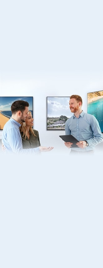 Samsung TVs hang on the walls. A couple consults someone on which TV to buy.