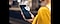 A hand holds a Galaxy S25 Ultra in front view. A Knox Vault logo is popping out from the screen to indicate data being protected on the device.