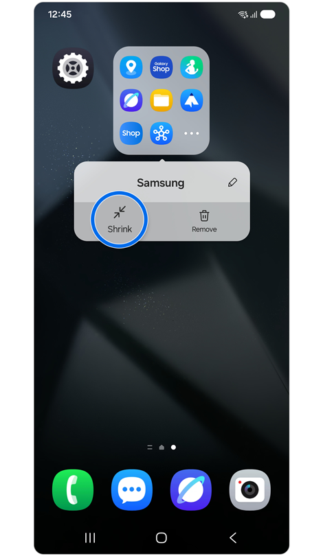 Home screen with a folder settings pop-up menu from an enlarged app folder with ‘Shrink’ highlighted.