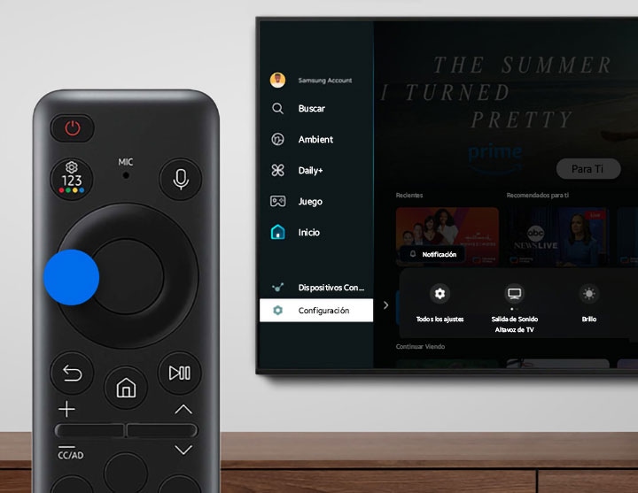Close-up of a Samsung Smart TV remote and the on-screen Settings menu displayed on the TV.